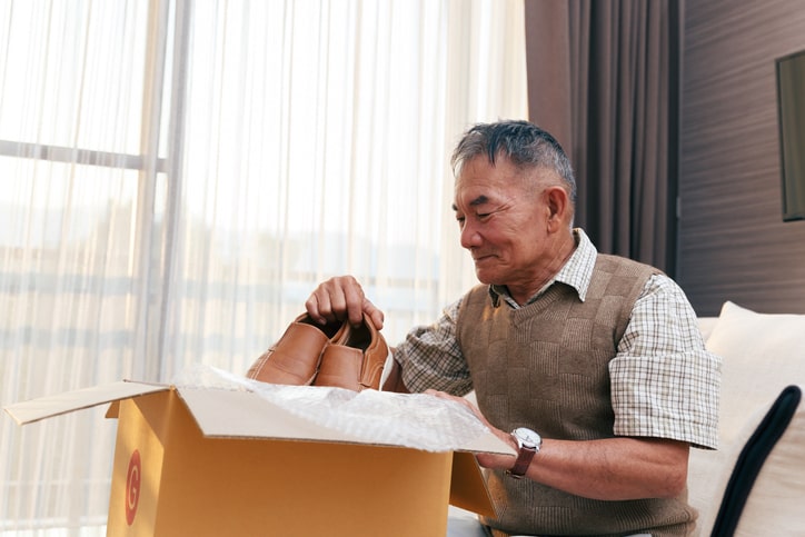 Mature Man Packing Shoes